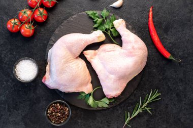 Çiğ tavuk bacakları malzemelerle kaplı. 