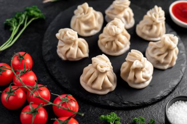 Lezzetli Gürcü khinkalileri siyah masada. 