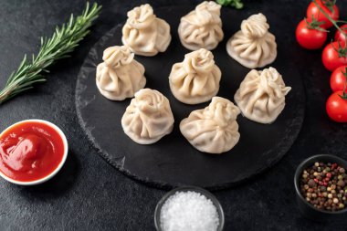 Lezzetli Gürcü khinkalileri siyah masada. 