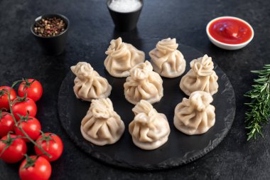 Lezzetli Gürcü khinkalileri siyah masada. 