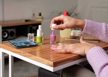 Woman on a beauty treatment of manicure at home. Close up image