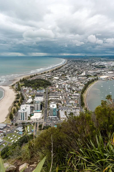 Mount Maunganui seen from the view point of the mountain on a beautiful summer day. New Zealand, Vertical photo