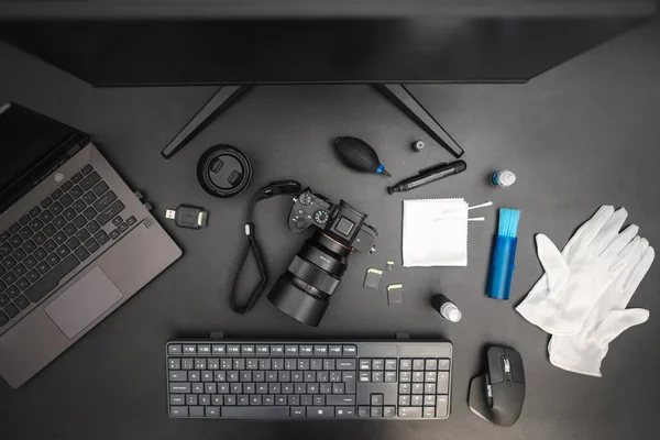 Top view of photographer cleaning kit on dark background. Professional photographer concept