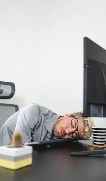 Businessman falling asleep in the office, Stress and overwork concept. Vertical photo