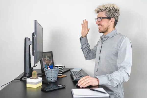Business man waving hands at computer while working at the office. New communication concept. White background