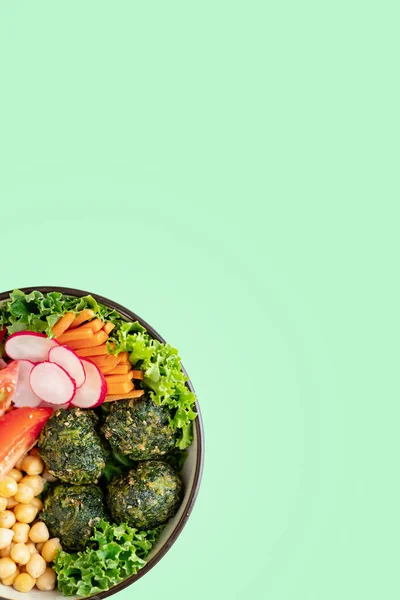 Plant based, vegan bowl of food. Top view. Copy space. Green Background