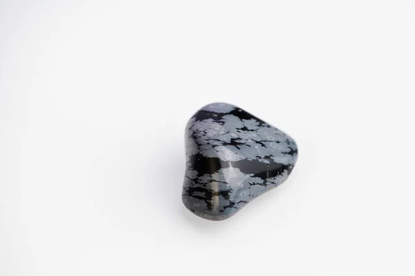 Schneeflocke Obsidian Edelstein auf weißem Hintergrund — Stockfoto