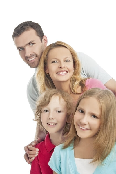 group of four standing together and smiling