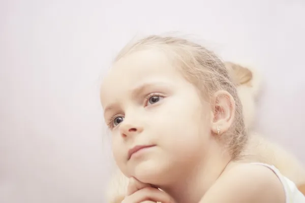 close up portrait of blond little girl thinking