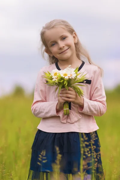 portrait of positive smiling blond girl with flowers