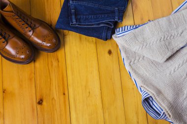 Kıyafet Kavramları. Üst Manzara Bronz Çizmeli Düz Çizme Kış Süveteri, Çizgili Gömlek, Tahta Yüzeyde Pantolon. Yatay Görüntü