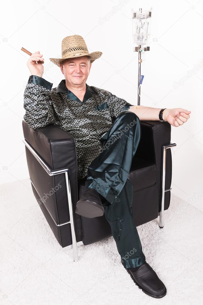 Man with cuban cigarette in chair