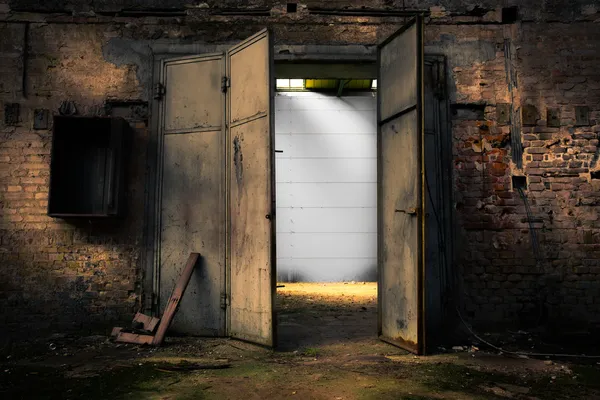Roestige metalen deur in een verlaten pakhuis Rechtenvrije Stockafbeeldingen