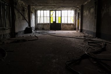 Abandoned industrial interior with low light clipart