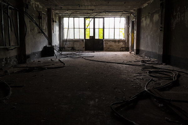 Abandoned industrial interior with low light