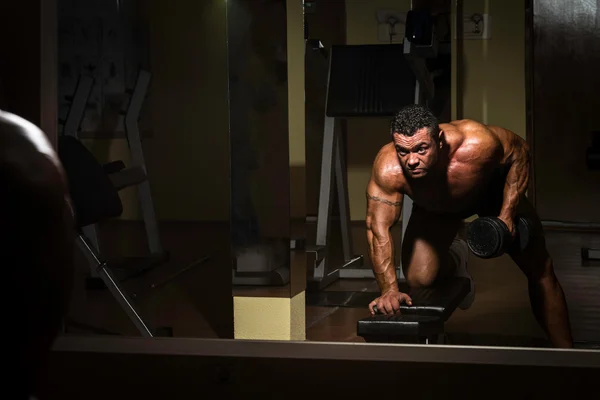 Male bodybuilder doing heavy weight exercise for back — Stock Photo, Image