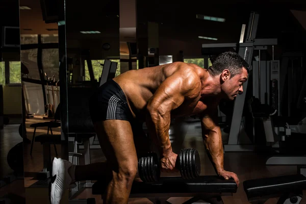 Male bodybuilder doing heavy weight exercise for back — Stock Photo, Image