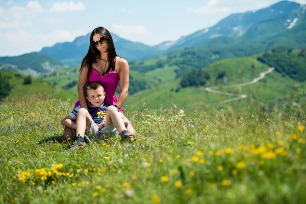 Mother and son sitting and playing — Stock Photo, Image