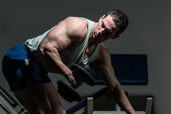 Young bodybuilder doing heavy weight exercise for back — Stock Photo, Image