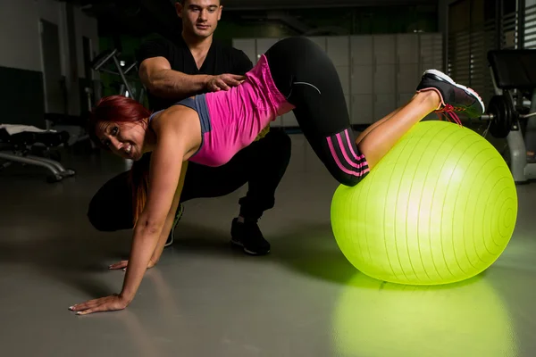 Young woman with personal trainer — Stock Photo, Image