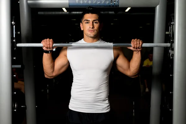Young Man Resting After Doing squats with barbells — Stock Photo, Image