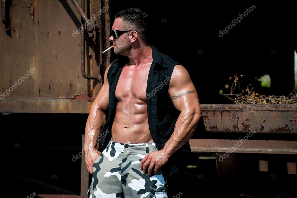 Bodybuilder Smoking A Cigar — Stock Photo © ibrak 34766023