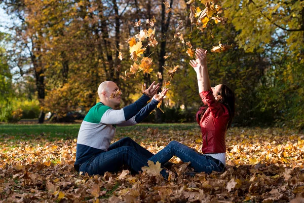 Pareja jugando juntos en el bosque fuera durante el otoño —  Fotos de Stock