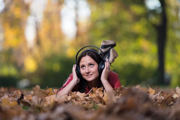 Smiling Female Listening To Music Autumn Royalty Free Stock Photos