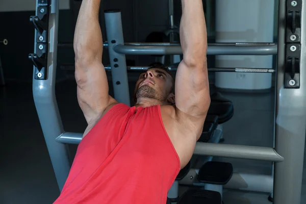 Man Lies On A Bench And Does Dumbbell Presses — Stock Photo, Image