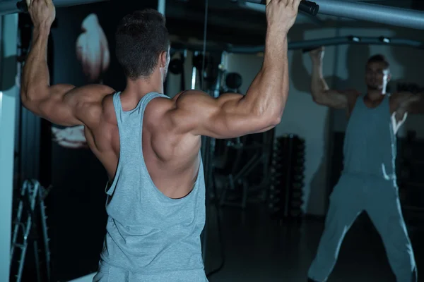 Culturista haciendo ejercicio para la espalda — Foto de Stock