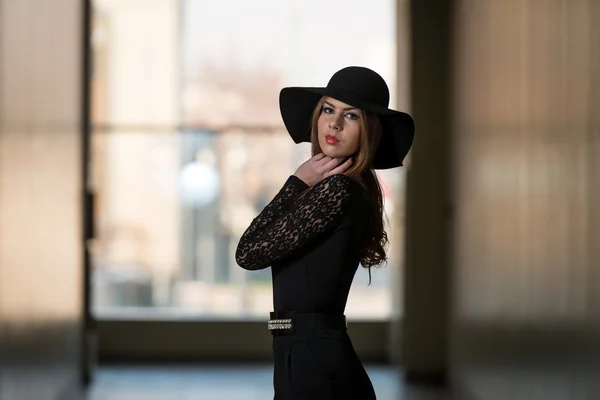 Elegante dame met stijlvolle hoed en lederen tas — Stockfoto