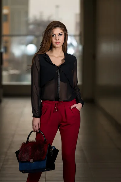 Superbe femme portant des pantalons rouges et des manches longues en mousseline de soie — Photo