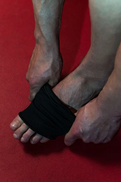 踢拳击手将带子放在他的脚上 — 图库照片
