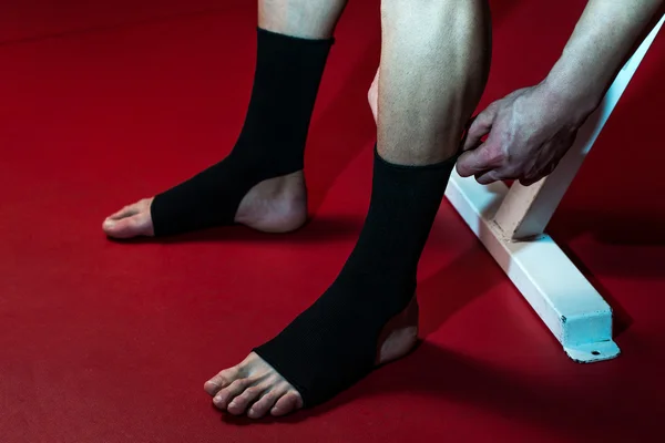 Boxer Putting On Straps Preparing For Combat