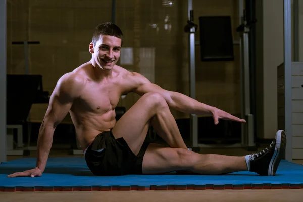 Athletic Man Stretches — Stock Photo, Image