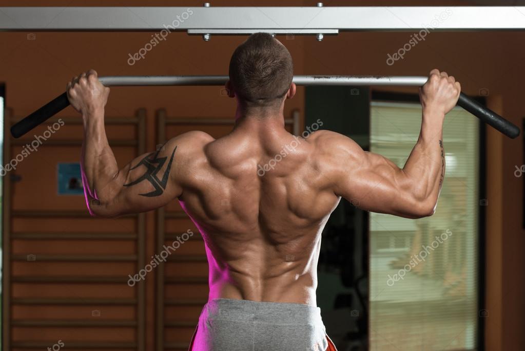 Male Athlete Doing Pull Ups — Stock Photo © ibrak 43857487