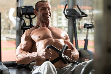 Egzersizler oturmuş satır makinede geri