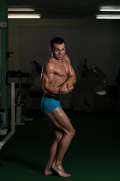 Bodybuilder effectuant des poses latérales de poitrine — Photo