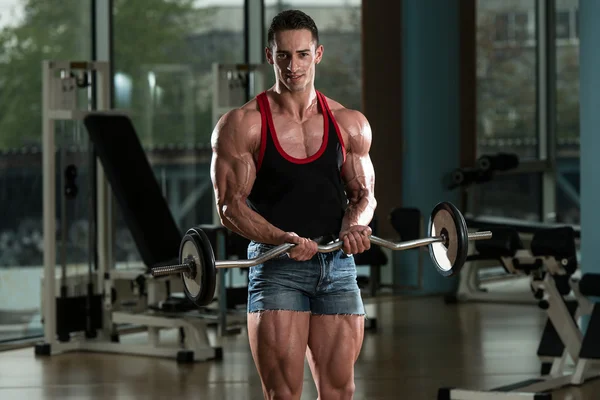 Bodybuilder Performing Biceps Curls With A Barbell — Stock Photo, Image