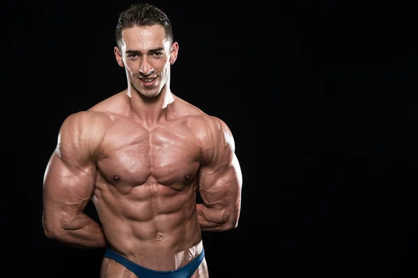 Young Bodybuilder Flexing Muscles Isolate On Black Blackground — Stock Photo, Image