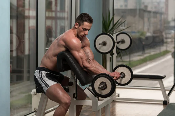 Bodybuilder Performing Biceps Curls With A Barbell — Stock Photo, Image
