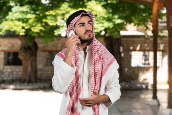 Saudiska Arabemiraten man använder en smart telefon — Stockfoto