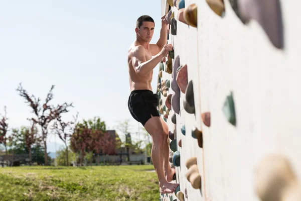 Jovem escalada parede rock ao ar livre — Fotografia de Stock