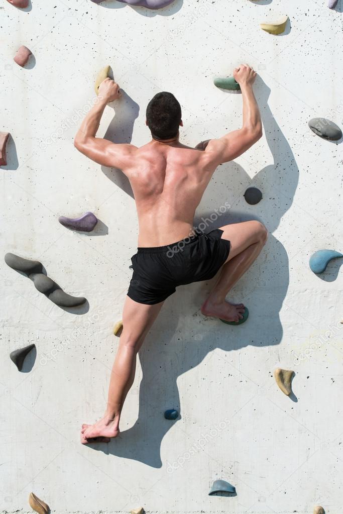 Young Man Climbing Wall Rock Outdoors
