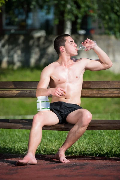 Young Muscular Man Drinking A Water Bottle — Stock Photo, Image