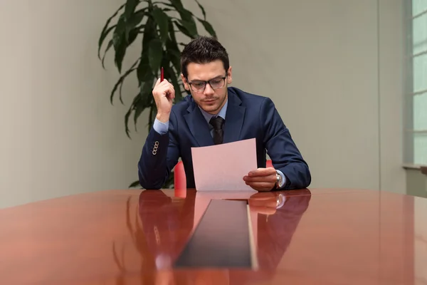 Portrait Of Attractive Businessman Reading Paper In Office — Stock Photo, Image