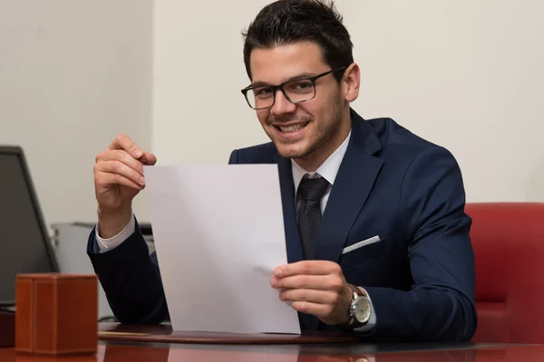 Young Businessman In Office Looking At Paper — Stock Photo, Image