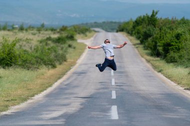 Sokak Otobanı 'nda zıplayan ve dışarıda eğlenen yakışıklı adam. 