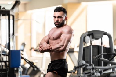 Spor Salonunda Güçlü Duran Genç Adam - Kas Atletik Vücut Geliştirici Spor Sonrası Spor Pozisyonu