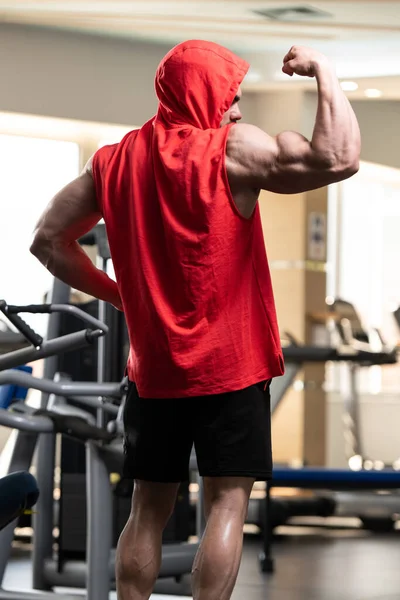 Healthy Young Man Standing Strong Gym Flexing Muscles Red Hoodie — Stock Photo, Image